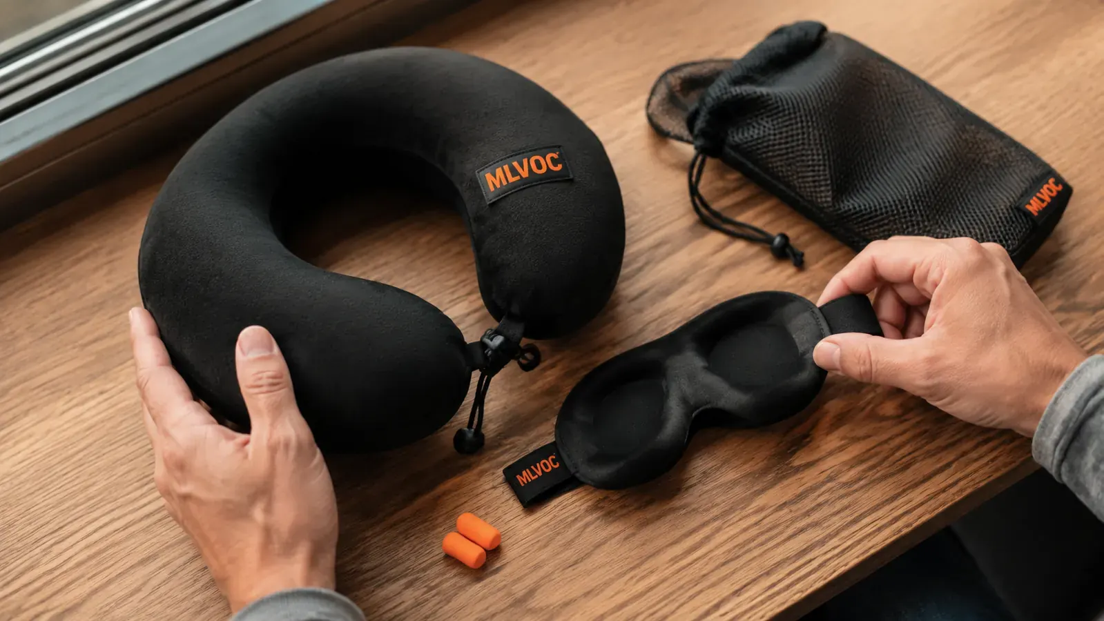 MLVOC memory foam travel pillow displayed with included eye mask, earplugs, and carry bag on a wooden surface
